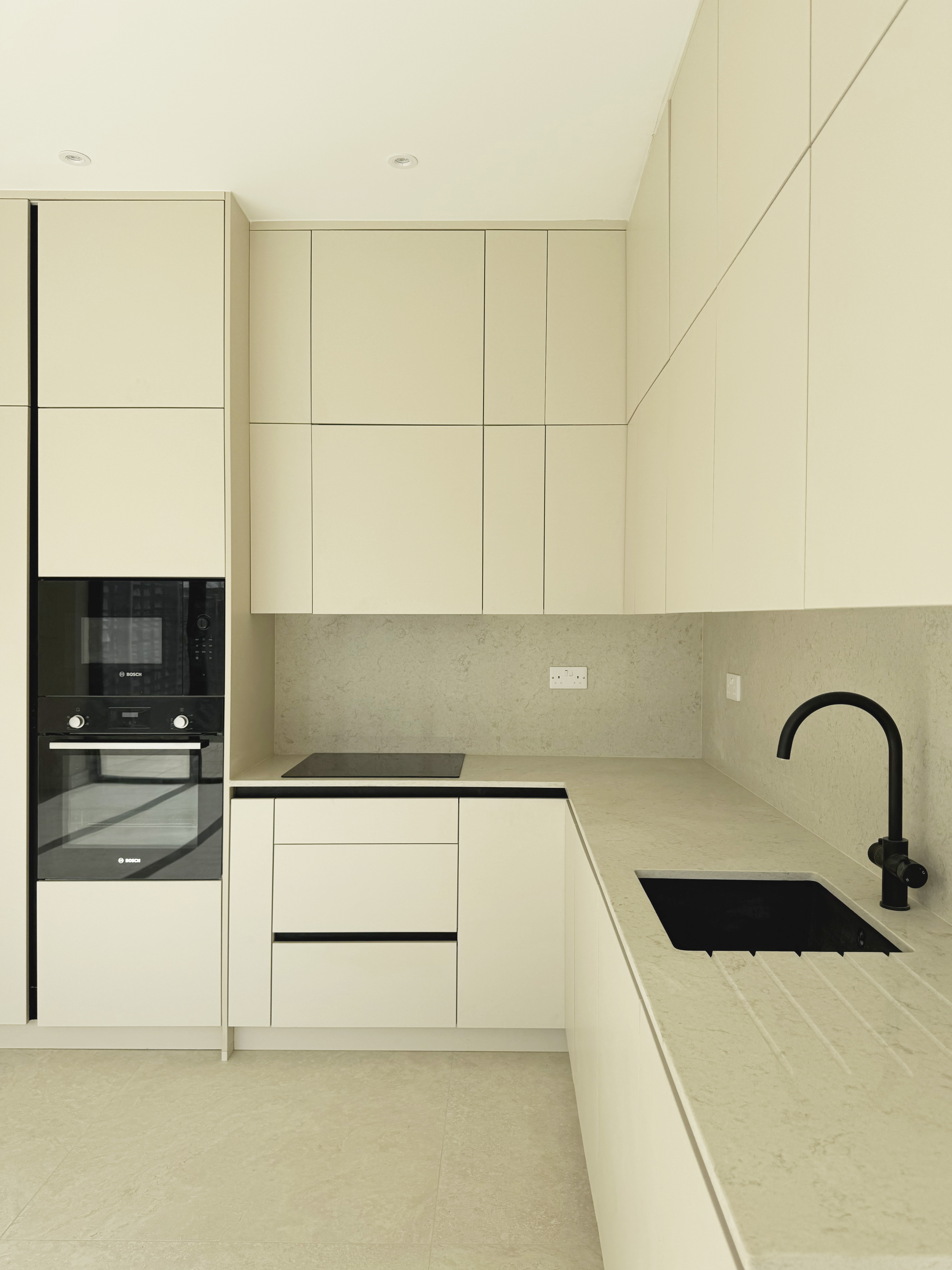Kitchen handleless units stone worktop